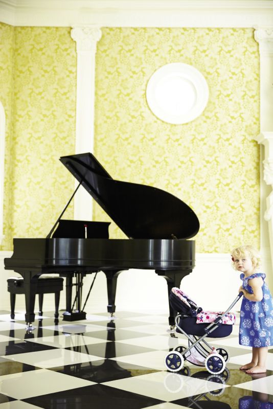 “The ballroom, with that volume and space, is pretty spectacular,” says Eddie Fava, but it suffered the most damage. Now polished and stately, the walls wear a fine Lee Jofa fabric, and a grand piano complements the marble floor.