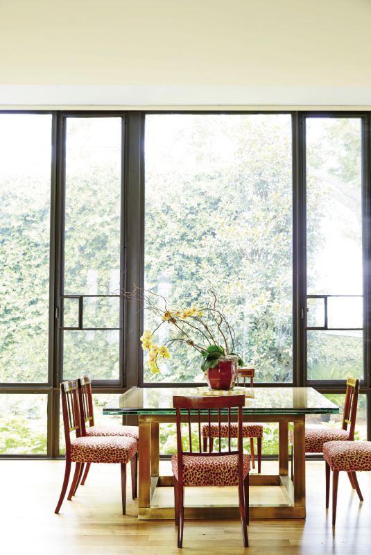 A wall of new floor-to-ceiling windows opens up the kitchen/breakfast/family room to bright morning light and garden views, as well as a peek-a-boo of the harbor to the east.