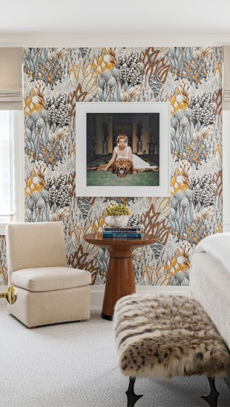 Scene Stealer: Slim Aarons’s 1959 photograph Beauty and the Beast is the centerpiece for the guest room. The golds and browns of the Casamance wallpaper are highlighted in the playful portrait and the Randolph & Hein “Taza” table.