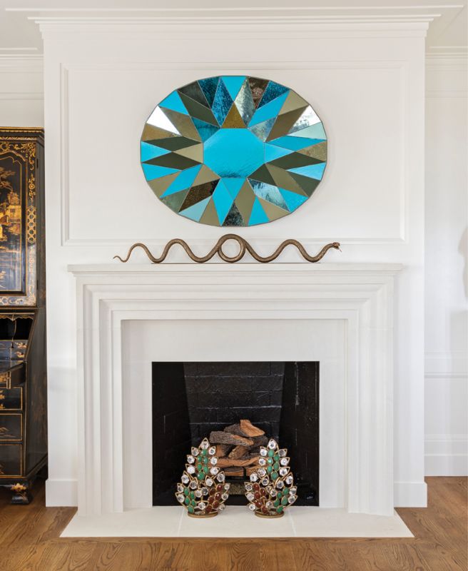 A pair of jeweled firedogs inspired by Van Cleef & Arpels earrings are but one example of the clever couture-driven designs found in a not-so-traditional Federal-style manse South of Broad.