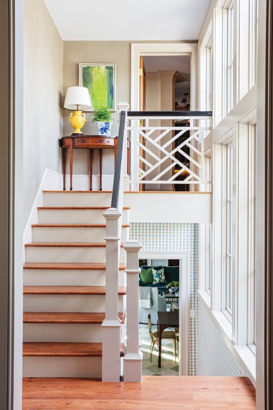 A hyphen connects to the primary suite upstairs and the Dorothy Draper-inspired pool house.