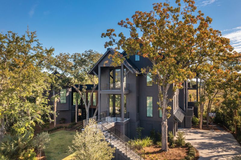 BACK IN BLACK: Nestled on the tip of Nobles Point in Daniel Island Park, the “Black House,” as it has become known, was designed by residential designer Neal Van Dalen to provide his clients, a family of six, with privacy and a closer connection to nature. Walls of windows help bring the outside in, and plenty of outdoor living space allows the family to soak in the spectacular views. The exterior paint color was the suggestion of designer Hollis Erickson, who repeated the hue inside.