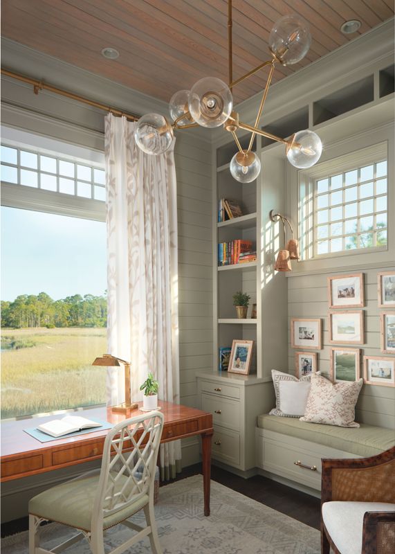 In Susan's office the walls are painted in Farrow & Ball “French Gray,” a Hickory Chair desk, and Visual Comfort bubble lamp light fixture add feminine flair.