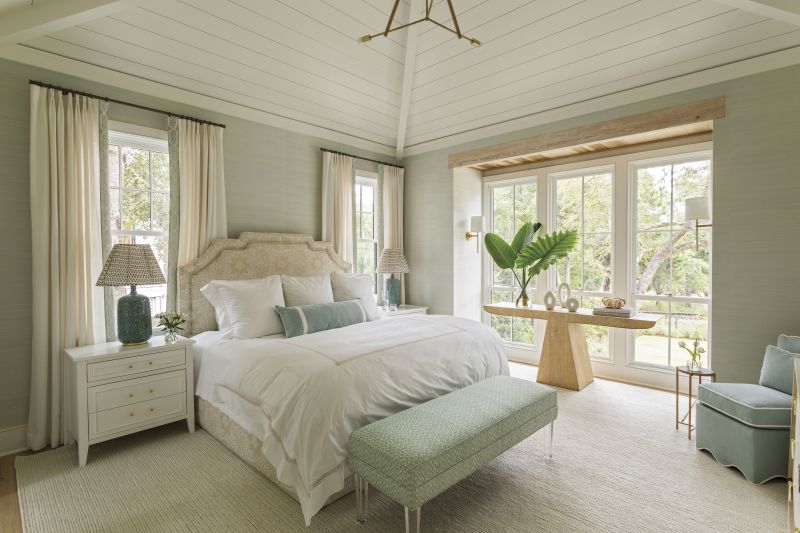Rest & Relaxation: The primary suite was designed as a counterpoint to the couple’s active lifestyle—they stay busy with golf, fly-fishing, and other outdoor pursuits. Elebash sourced plush upholstery, including a custom headboard wrapped in Ann McGuire Studio fabric and a scalloped slipper chair by Oomph. A floor-to-ceiling window alcove brings the outdoors in.