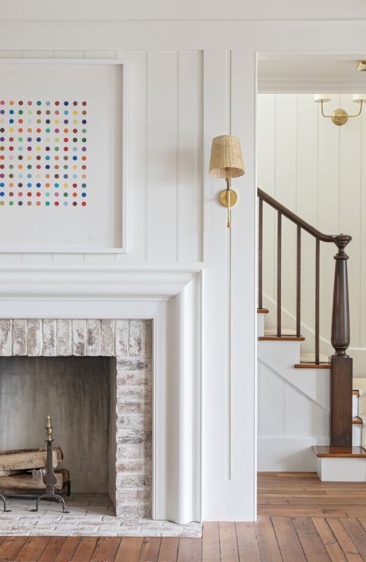 The mantelpiece frames the Damien Hirst spot painting.