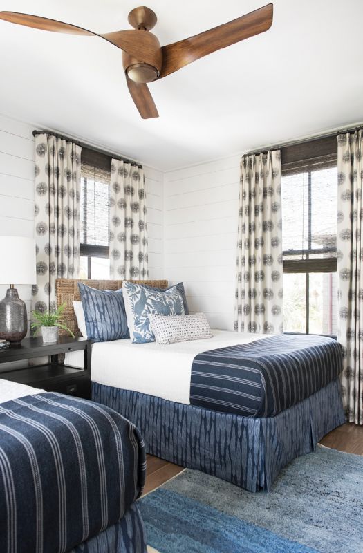 The large, double guest room is layered in blues, from the FAYCE Textiles bed skirts and shams to the ombré blue rug sourced in Morocco