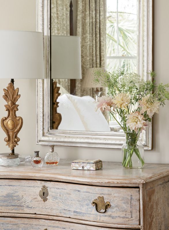 A Louis Philippe mirror tops a serpentine dresser.
