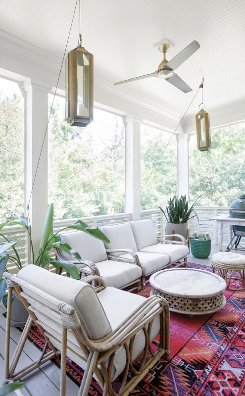 Chill & Grill: Newly screened-in, the back porch off the main living area offers more space for cooking and entertaining. Erin had the vintage rattan seating recovered by Aiden Fabrics, and Spence created a pulley system for the lanterns.