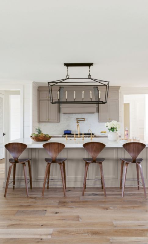 Style & Simplicity: A minimalist kitchen is accented by mid-century modern stools from Design Within Reach, while the usual cooking accoutrements can be found in the butler’s pantry, right off the kitchen.
