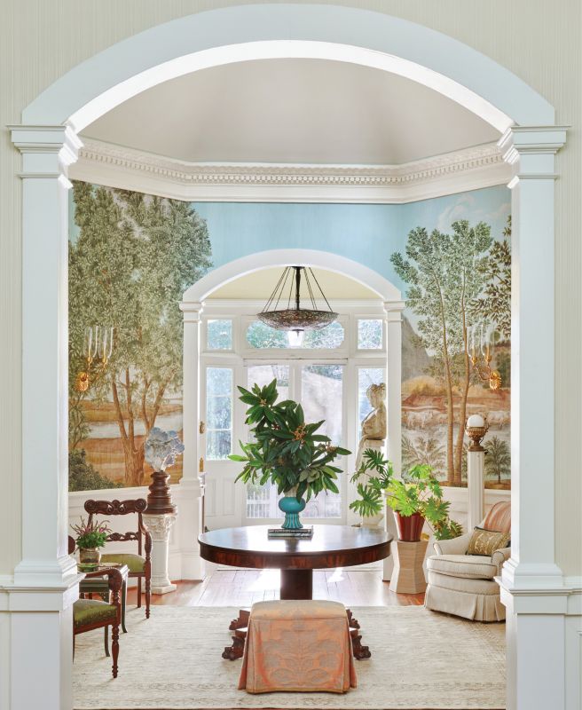 Designer Alaina Michelle Ralph transformed this nearly 150-year-old Summerville home with a careful selection of period-appropriate antiques and a showstopping Iksel wallpaper depicting the Italian countryside to complement the Italianate architecture.