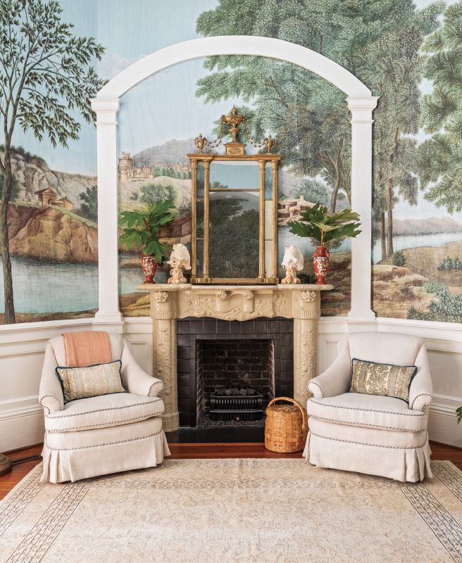 Gather round: Furnishing the rotunda was a challenge. Ralph created two distinct seating areas, one around the fireplace, above which she added a large antique mirror to help reflect natural light from the skylight, and the other occupying the opposite side. She tied the spaces together with a large vintage Oushak rug.