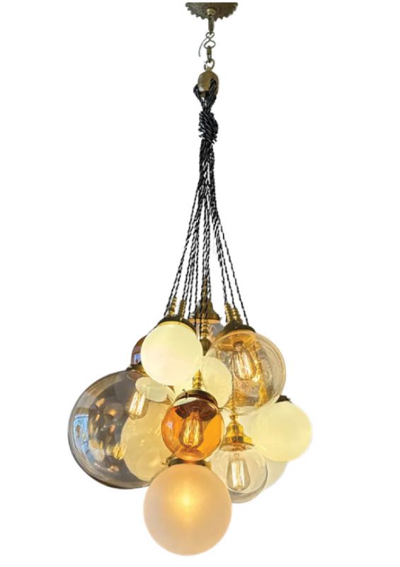 The “Ann” orb chandelier; the studio allows clients to customize their fixtures with an array of glass, wood, and semiprecious beads, such as “Skylight” agate and “White Swirl”