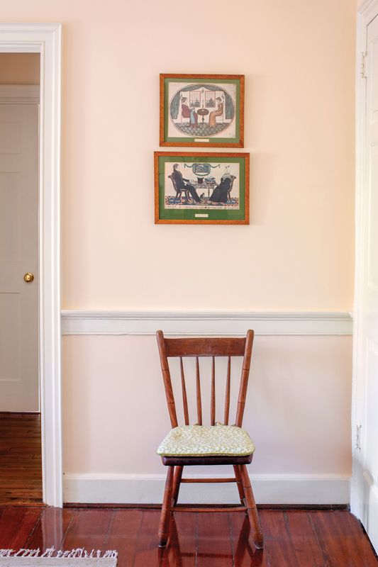Vintage prints depicting couples enjoying tea add to the whimsical feel of this room.