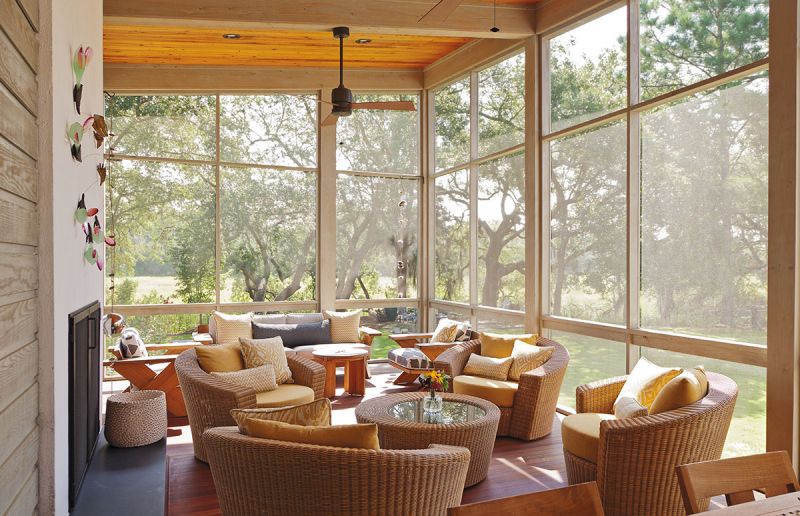 The screened living room (above) is the homeowner’s happy place. A favorite art piece—The Sowing, a sculpture by Charles Savoie—jazzes up the stucco-and-slate fireplace.