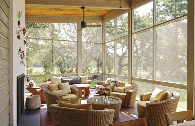 The screened-in living room is the homeowner’s happy place. One of her most recent art acquisitions—The Sowing, a sculpture by Charles Savoie—jazzes up the stucco-and-slate fireplace. Otherwise, the space is outfitted simply with teak furnishings and woven chairs, so as not to distract from views of the gorgeous wetlands and live oaks.