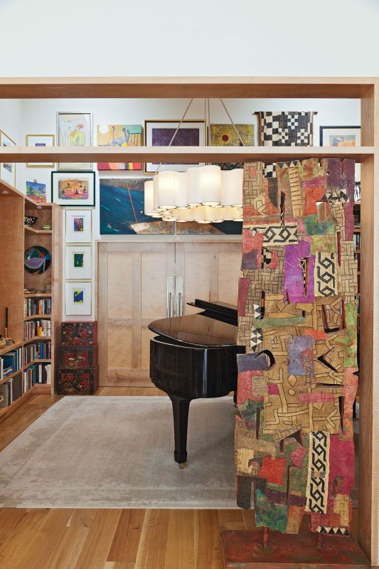 “The challenge was to have as many windows as possible, but also a lot of wall space for her art,” says interior designer Lauren Sanchez. Many works, including the William Halsey sculpture that fits right into the doorway, found a home in this music room.