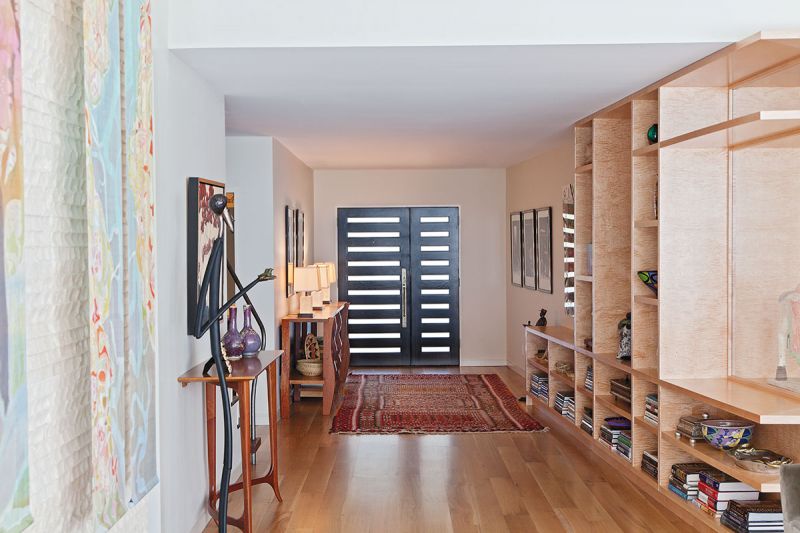 Architect Reggie Gibson designed the angled wall that runs alongside the entryway to draw visitors into the home.