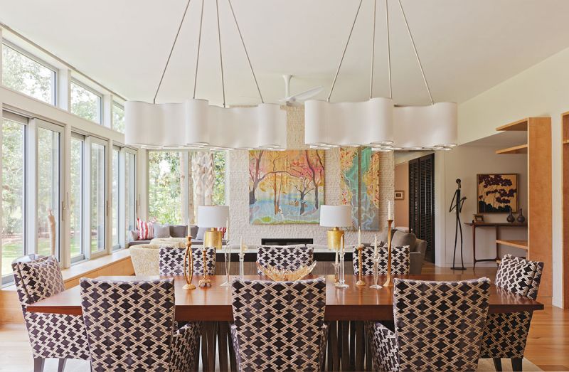 A neutral color palette ensures the interior design complements the stunning views and prized artworks, like the black-and-white Andy Warhol in the kitchen (above) and the three-panel batik by local artist Mary Edna Fraser displayed against the split-face stone tile fireplace in the living room