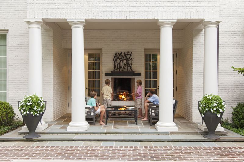 COMFORT ZONE: On fall evenings, the whole gang gathers around the outdoor fireplace to catch up on the day’s events (above).