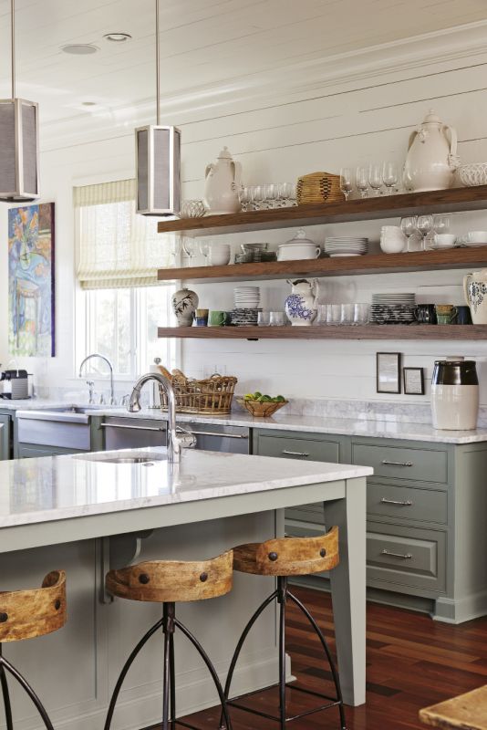 Bishop suggested replacing wall-mounted cabinets with open walnut shelving for storage with more warmth and personality.