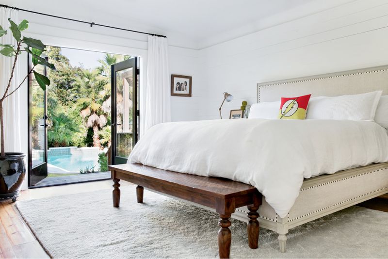 French doors lead to a pool and a striking cabana designed by David Thompson.