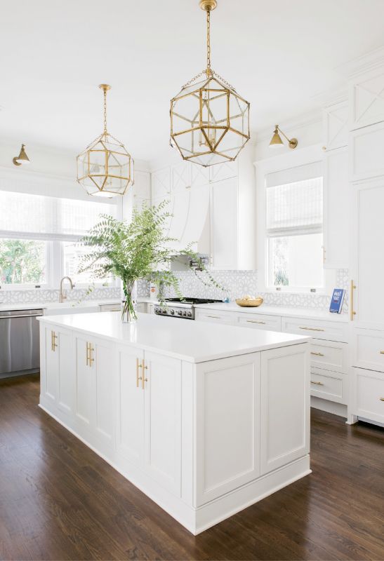 LIGHT & BRIGHT: “The kitchen is a good example of what Melissa did so well, filling every nook and cranny and making them useful in some way,” says Alison. Fireclay backsplash and gold pendants and sconces add glamour to the utilitarian space.