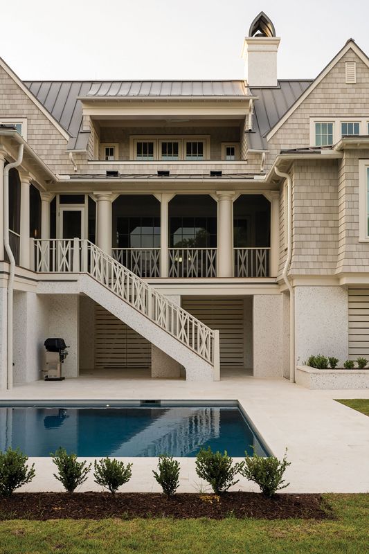 Blending in: The soft exterior palette was designed to mesh with the surrounding coastal landscape. From the light-colored NuCedar shingles and the tabby stucco to the Marvin clad windows in “Coconut Cream,” the overall look is subtle and sophisticated.