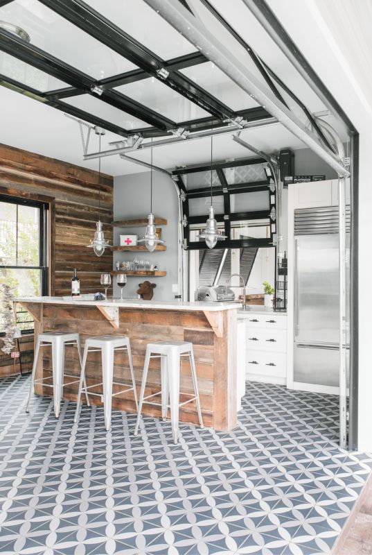 Open-Door Policy: A roll-up glass door connects the pool-house kitchen with the patio; a miniature version links to the outdoor bar and grilling station.