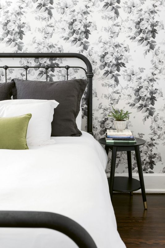 SWEET DREAMS - Alison’s mom visits often from Oklahoma, so a restful guest room was on the couple’s wish list. A metal spindle bed from Celadon, crisp white bed linens, and a vintage bedside table—all layered against House of Hackney’s “London Rose”-papered walls—delivers with aplomb.