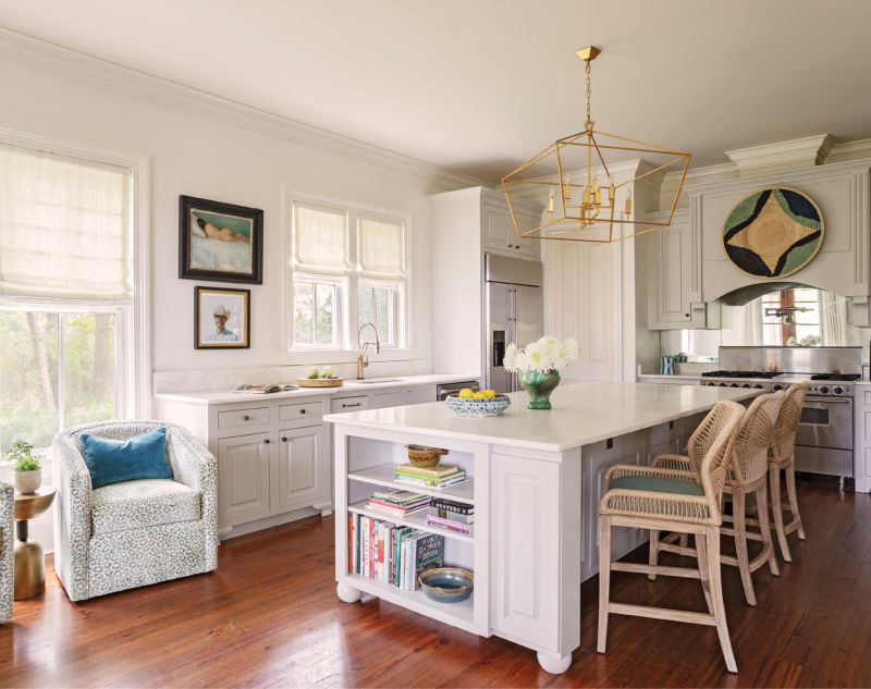 Open Up: In the kitchen, they removed built-in cabinets above the countertops and relocated them to a little-used mudroom off the kitchen, turning it in to a butler’s pantry to wrangle small appliances. New honed marble countertops, Hickory Furniture bar stools upholstered in Brunschwig & Fils “La Panthere” velvet, and a striking chandelier from Lyndon Leigh spruce up the well-loved room.