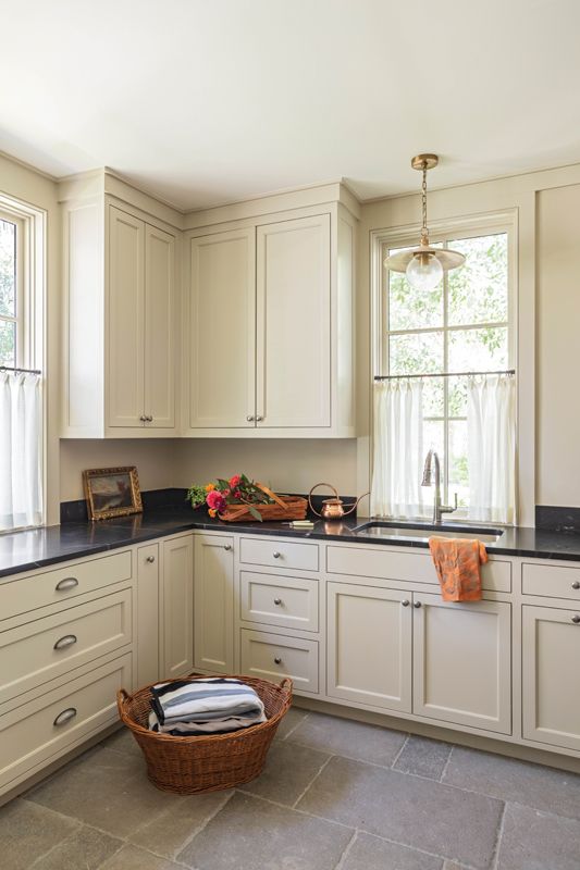 Adjoining the kitchen and part of the addition, these spaces feature expansive custom cabinetry, providing ample storage for the family.
