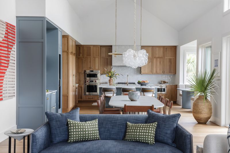The key to opening up the house was removing a fireplace/wall between what is now the kitchen and the living room, along with a room above it.