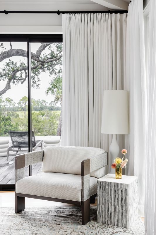 A Palecek chair serves as a cozy reading nook.