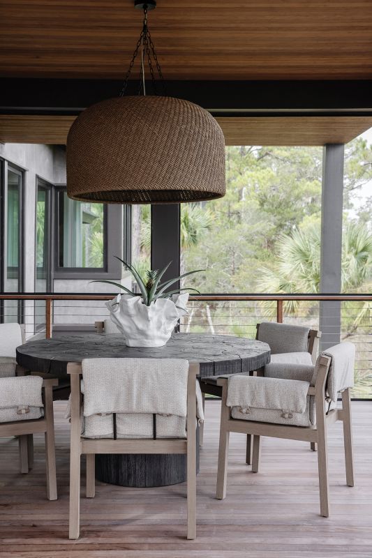 A puzzle-style dining table made from logs pieced together provides an intriguing conversation piece, while allowing for alfresco dining on the porch.
