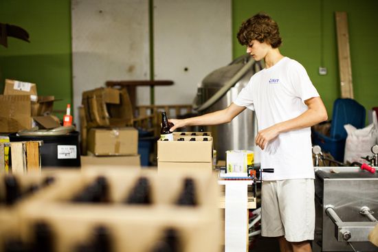 Son Kai labels bottles in preparation for boxing.