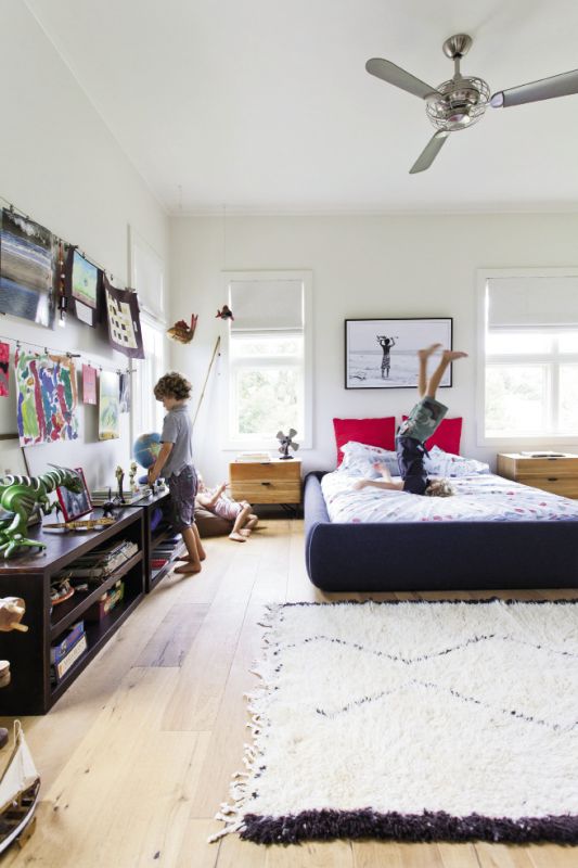 Max's room is dressed with rows of art projects and a framed surfer pic