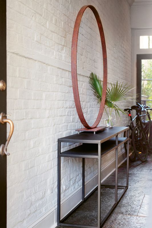 Inside, visitors are met with an antique carriage wheel; the sculptural metal object by stylist and artist Nathalie Naylor could easily be mistaken for a work of modern art.