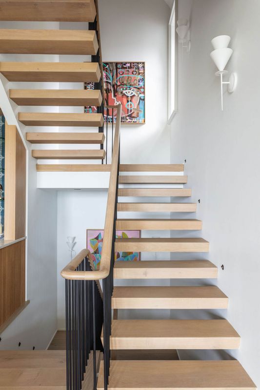 Fe Face 2023 by Sally King Benedict adds a pop of color on the landing.