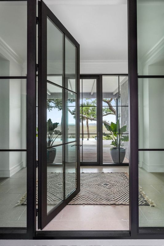A sculptural glass entryway and a floating staircase create elements of excitement in the space.