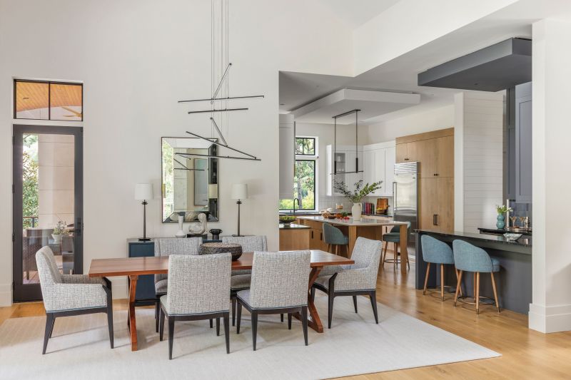 The homeowners’ existing wood dining table was paired with new chairs from Hickory Chair and a deep blue sideboard from Old Biscayne.
