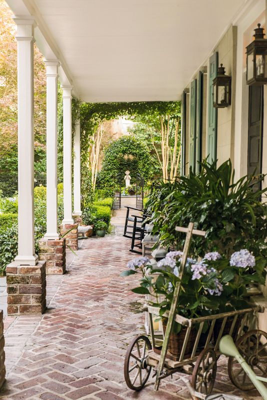 From the first-floor piazza, the eye is drawn down the center path of the parterre garden into the rear courtyard. Like much of Monica’s statuary, the figure of Pan (the Greek god of nature and shepherds) came from her garden in California.