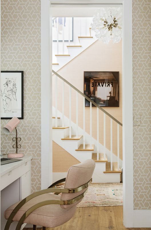 Corner Office: Tucked in the laundry room/butler’s pantry, Jenny’s home office features whimsical wallpaper by Cowtan & Tout, a mid-century French lamp, and a favorite Slava Roubanov sketch from Charleston Artist Collective. The adjoining hallway showcases a vintage chandelier from 1stdibs and Mona Kuhn’s Private from Jackson Fine Art in Atlanta.