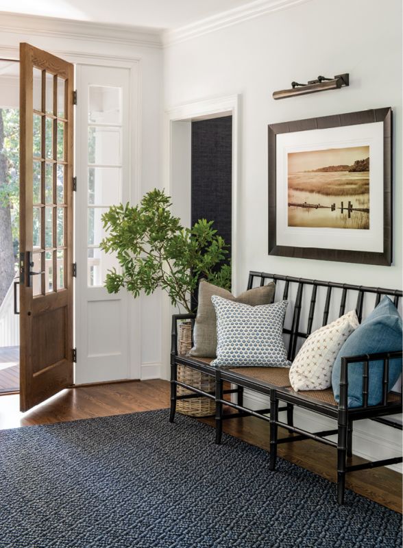 Inside, the entryway was reconfigured, adding a wall specifically designed to hang photographer Ben Ham’s marsh scene on one side and a TV on the other.