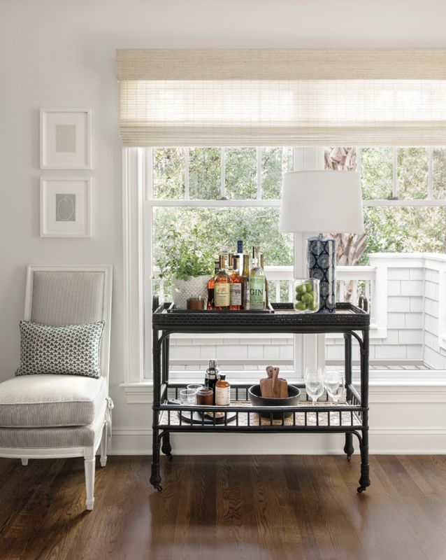 A bar cart from Serena & Lily connects the living room with the adjoining dining area.