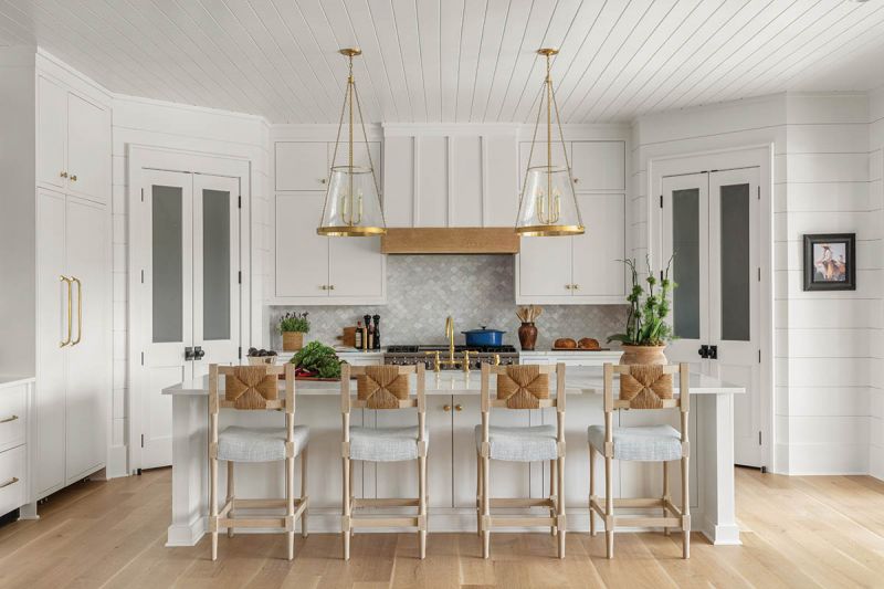 A wood-accented hood complements the 1940s-inspired “Athletic Club” counter stools, by Hollywood at Home by Peter Dunham. The beadboard ceiling is a throwback to early beach houses on Sullivan’s Island.