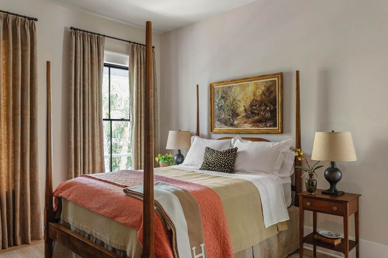 The downstairs guest room is filled with furnishings from the couple’s Old Village primary bedroom, including a Boykin Furniture Company pencil-post bed crafted by Joe Mazurek.