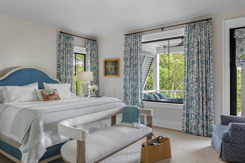A Hickory Chair “Simone” bed and Carleton V curtains in “Oxus” pair with a bench from Michael Mitchell in the upstairs guest room.