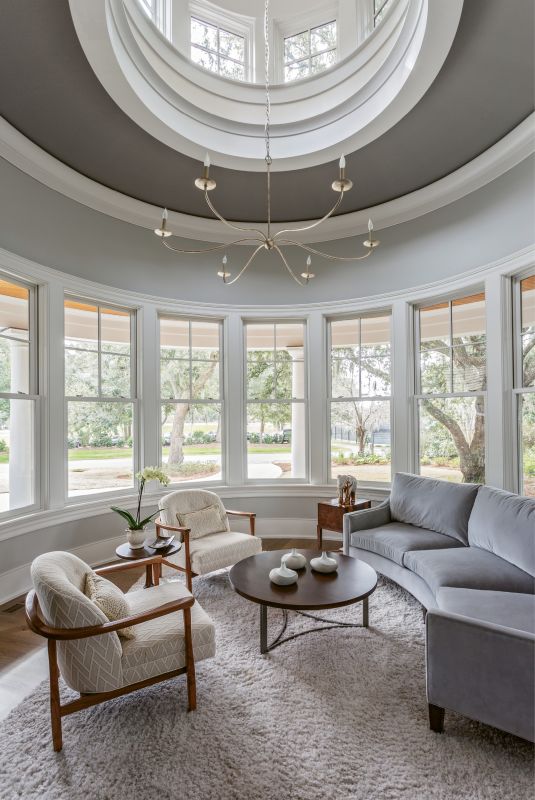 SIT BACK & RELAX: “When we were furnishing the home, the focus was always on how the spaces would be used,” says Theresa T. Morton of Studio TTM, one of the project’s interior designers. Copious seating areas, such as the circular sitting room and upstairs den, boast a multitude of comfy chairs and oversized sofas from Precedent and Sherrill in a collection of subtle, patterned fabrics that complement the exterior views without detracting from their splendor.
