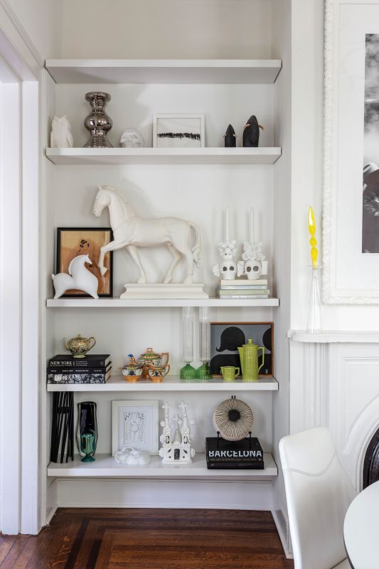 The dining room bookshelves display art, ceramics, and memorabilia from Mexico and other travels.