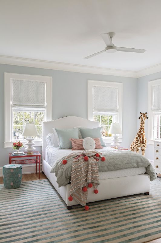 SWEET DREAMS: The nursery will become a guest room when baby Tucker (whose crib is not pictured) joins his brother in the “boys’ room.” Dominated by an Elson & Company rug, the space blends elegance and whimsy, from the Benjamin Moore “Ice Cap” paint to the coral bedside tables from Elizabeth Stuart Designs to a friendly stuffed giraffe.